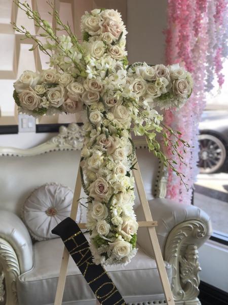 Blush and white flowers cross.