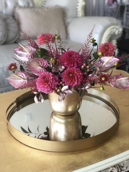 Cranberry Dahlias with rose gold Anthurium, pink Coffee bean, highlighted with mixed greens and rose gold.