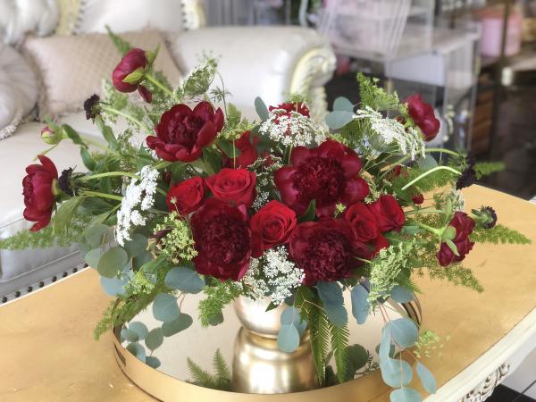red Peony are paired with beautiful velvety red roses in this garden style arrangement